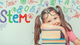 STEM word and symbols over beautiful cute little girl with books. modern education concept